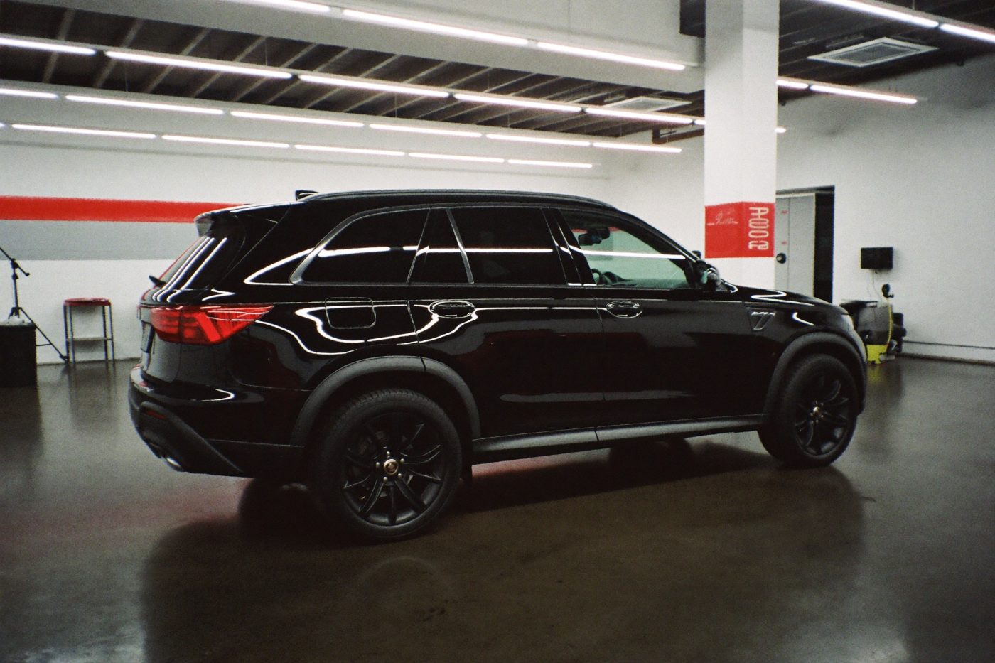 Car on a lift in a clean auto shop bay